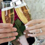 Newly married couple shares a glass of champagne at the wedding reception.