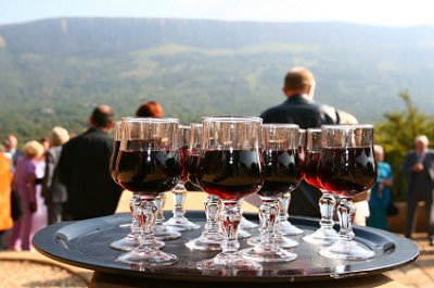 Wedding guests congregate as red wine is being served at the cocktail hour.