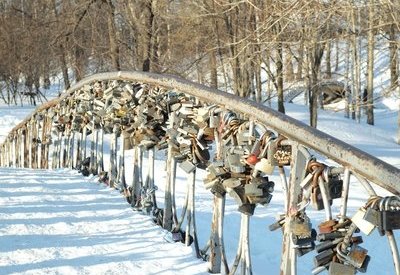 Locks adorn a snow-covered bridge as part of a traditional Russian wedding.