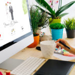 Web designer styling a wedding website at at her desk