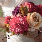 Bride carries her elegant muted rose, violet and gold themed bouquet.