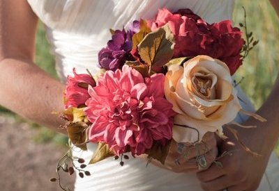 Bride carries her elegant muted rose, violet and gold themed bouquet.