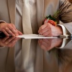 Groom signs marriage licence on the wedding day.