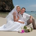 Happy couple poses for the camera on a remote island getaway.