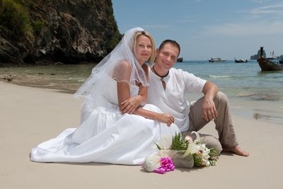 Happy couple poses for the camera on a remote island getaway.