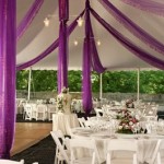 White and purple themed outdoor wedding reception.