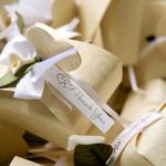 Heart themed wedding favor boxes with white thank you ribbon.