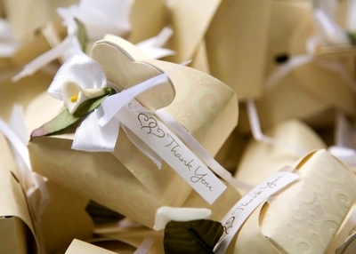 Heart themed wedding favor boxes with white thank you ribbon.